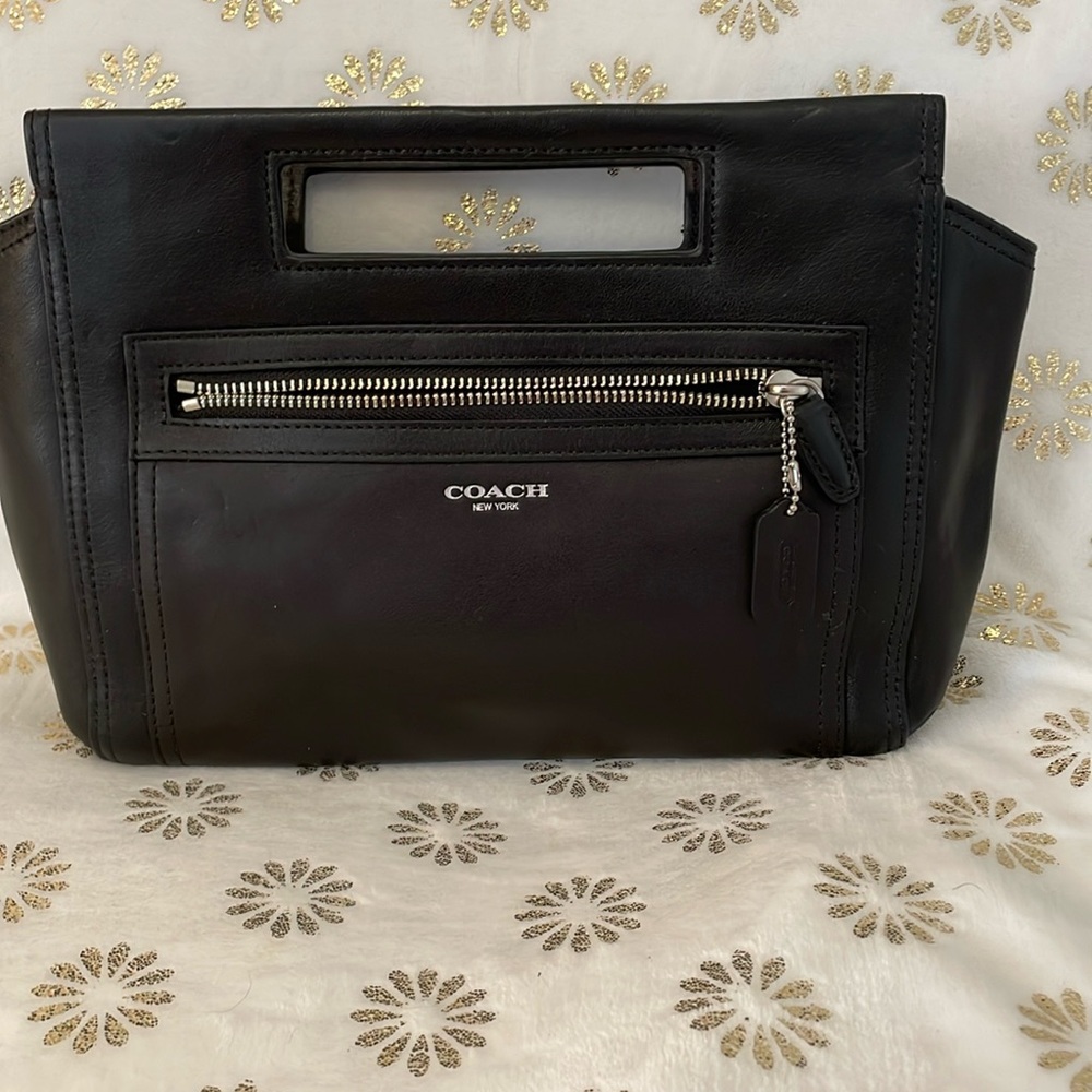 Black little bag. Would be great for going out as the top totally zips up. 11x8”